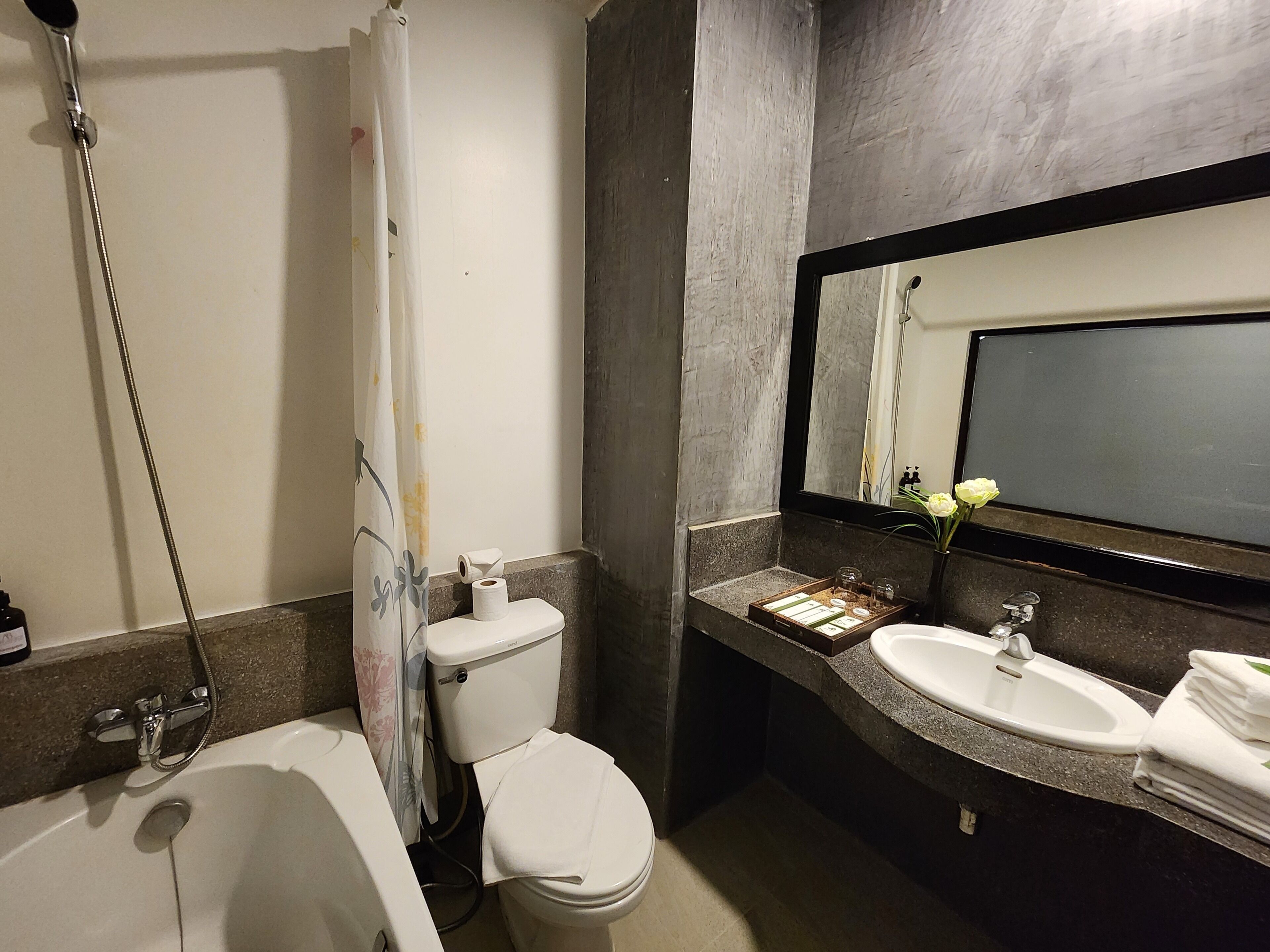 A bathroom with a bathtub, toilet, and sink.