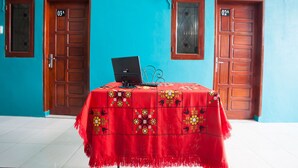 A room with a red tablecloth, a laptop, and two wooden doors labeled 03A and 02A. - OYO 1978 Pondok Indah Residence (Medan)