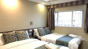 A hotel room with two beds, a window with curtains, a bedside table with a kettle, and a Wi-Fi sign on the wall. - Starry Inn (Kowloon)