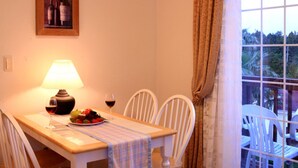 A dining table with a lamp, wine glasses, and a plate of fruit. - Dasom Pension (Seogwipo)