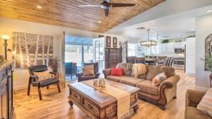 A spacious living room with a wooden ceiling, a large coffee table, and a sofa. - Heated Pool, Views, & Trail Access: Phoenix Escape (Phoenix (Ahwatukee))