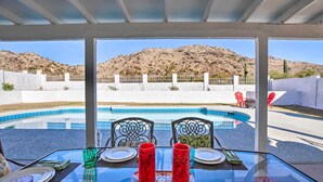 A glass table set for dining with a pool and mountains in the background. - Heated Pool, Views, & Trail Access: Phoenix Escape (Phoenix (Ahwatukee))