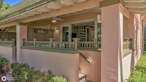 A two-story building with a covered porch, a sign for 'TIKI BAR', and a staircase leading to the upper level.