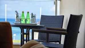 A balcony with a table and chairs, overlooking the sea. - 1 Bedroom apartment located in the heart of protaras. (Protaras)
