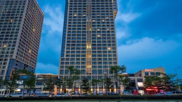 A high-rise building with a grid of windows and a central vertical feature. - Floral Hotel Frozen Adventure Guangzhou (Guangzhou)