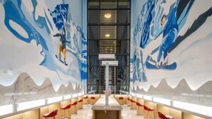 A modern interior with a long bar area, high ceilings, and large windows. - Floral Hotel Frozen Adventure Guangzhou (Guangzhou)