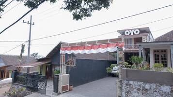 A building with a sign reading "OYO" and a gated entrance.