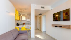 A modern apartment with a living room, a kitchen, and a dining area. - Gardaliva studio: in small residence with pool near to the lake (Manerba del Garda)