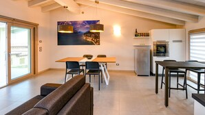 A modern kitchen with white cabinets, a built-in oven, and a refrigerator. - Gardaliva5: with lake view in new residence with pool near to the lake (Manerba del Garda)