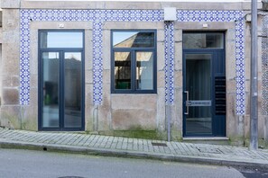 Stunning building facade with patterned tile border and large windows.