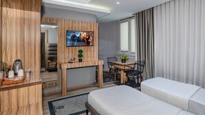 A modern hotel room with a bed, a desk with a TV, a dining area, and a large window with curtains. - Dem İstanbul Airport Hotel (Istanbul)