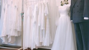 A bridal boutique with various wedding dresses on display and a mannequin in a wedding gown. - Wedding House (Seogwipo)