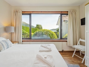 A hotel room with a large window, a bed, a chair, a lamp, and a radiator. - Shore House  - sleeps 10 guests  in 5 bedrooms (Tarbet, Arrochar)