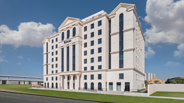 A large, multi-story hotel with a classic architectural style, featuring a prominent entrance and a name sign. - JA The Manor Hotel, Dubai (Dubai)