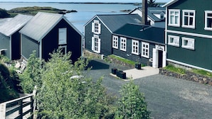 A row of traditional houses with a view of the sea. - The Crib Rocks (Borgarnes)