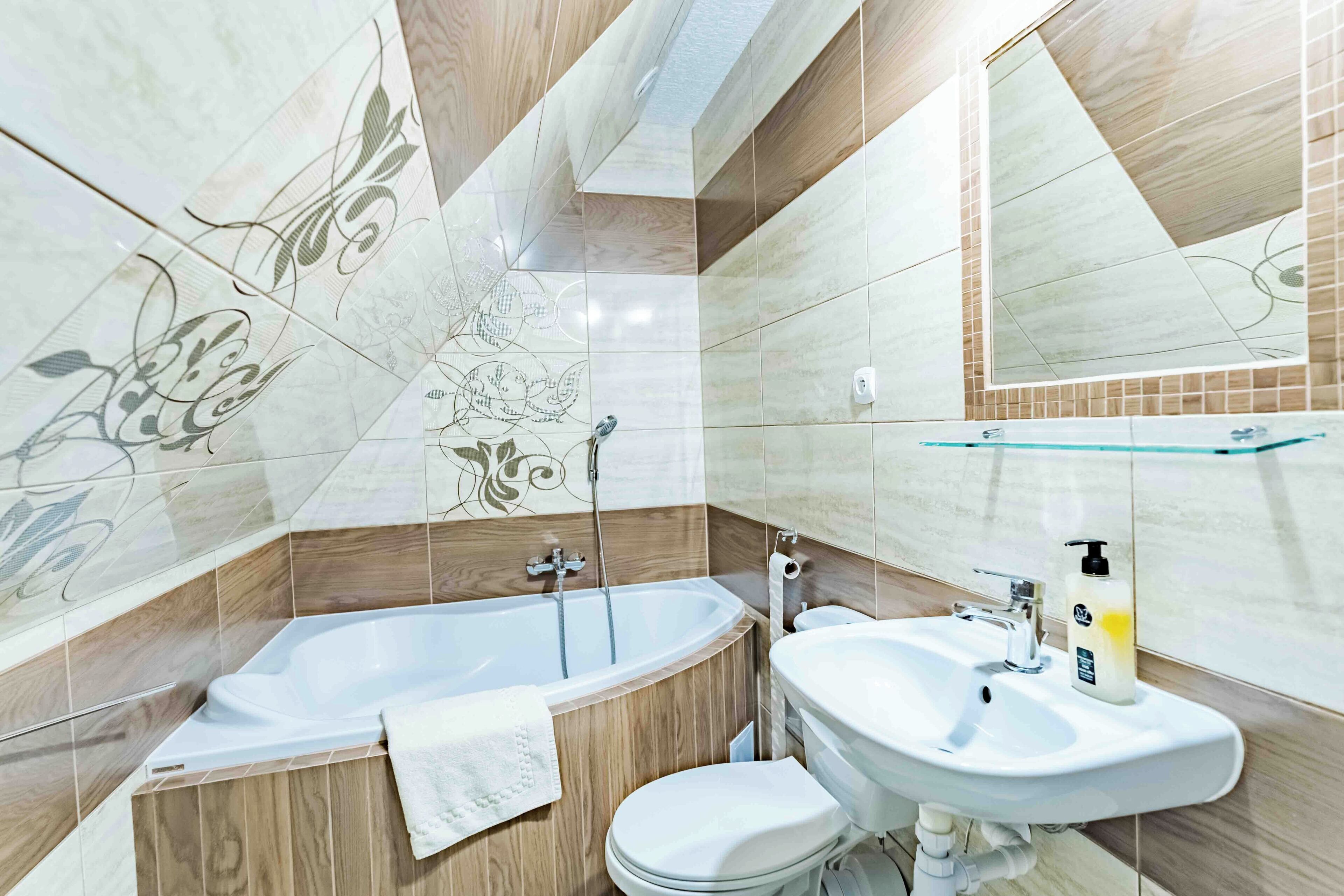 A modern bathroom with a freestanding bathtub, a sink, and a toilet.