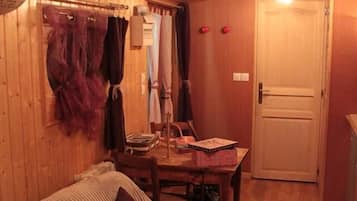 Una habitación acogedora con cama, una mesa y una puerta.