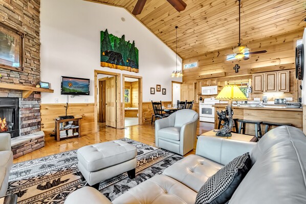 A spacious living room with a fireplace, a television, and a dining area with a table and chairs. - Smoky Mountain Views - AWESOME MOUNTAIN VIEWS, $560 FREE tickets each paid day (Sevierville)
