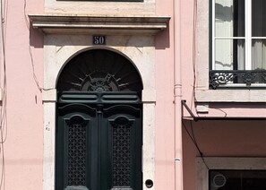 A building facade with a double door, a number '50' above the door, and a window with decorative ironwork. - in. gracia charming studio - city center - grace district - alfama (Lisboa)