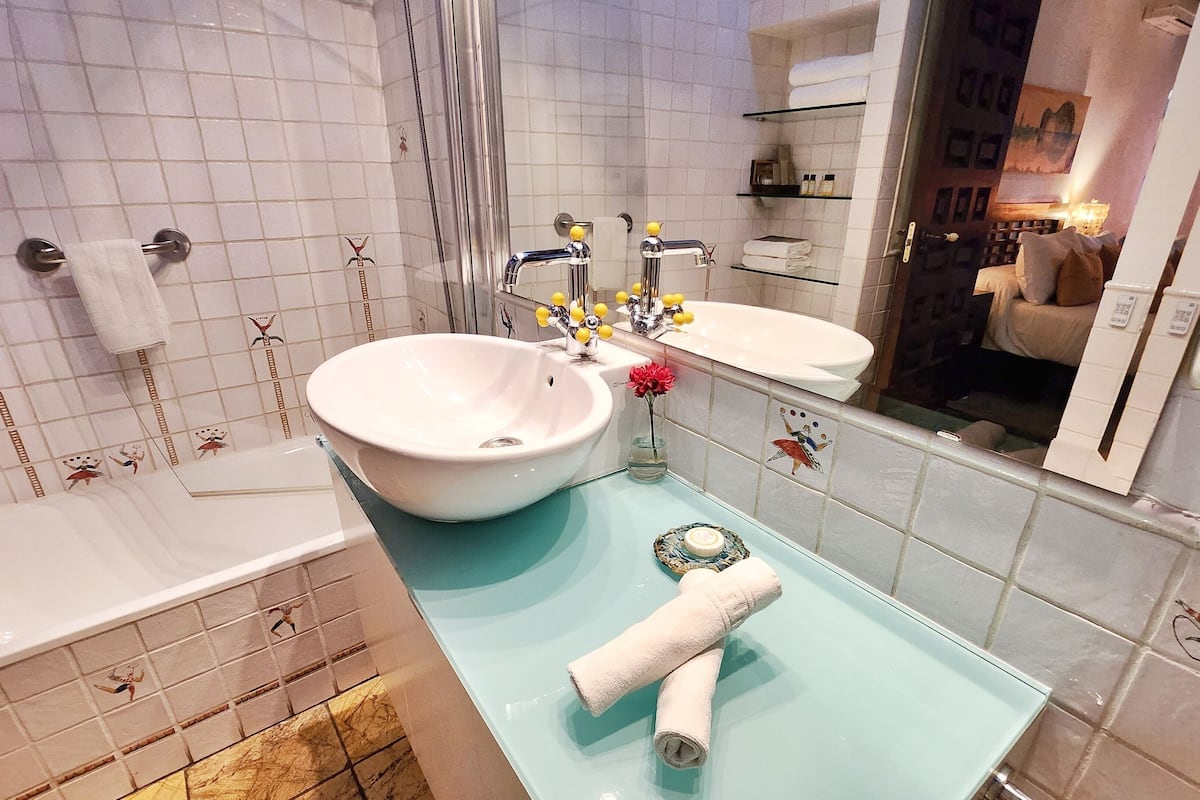 deluxe double room | bathroom | rainfall showerhead, free toiletries, hair dryer, bathrobes