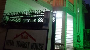 A multi-story building with a balcony and string lights. A sign indicates it is the "Royal Tourist House." - BnB Royal Tourist House (Kathmandu)