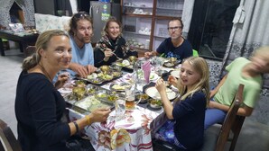 A group of people dining at a table with various dishes and drinks. - BnB Royal Tourist House (Kathmandu)
