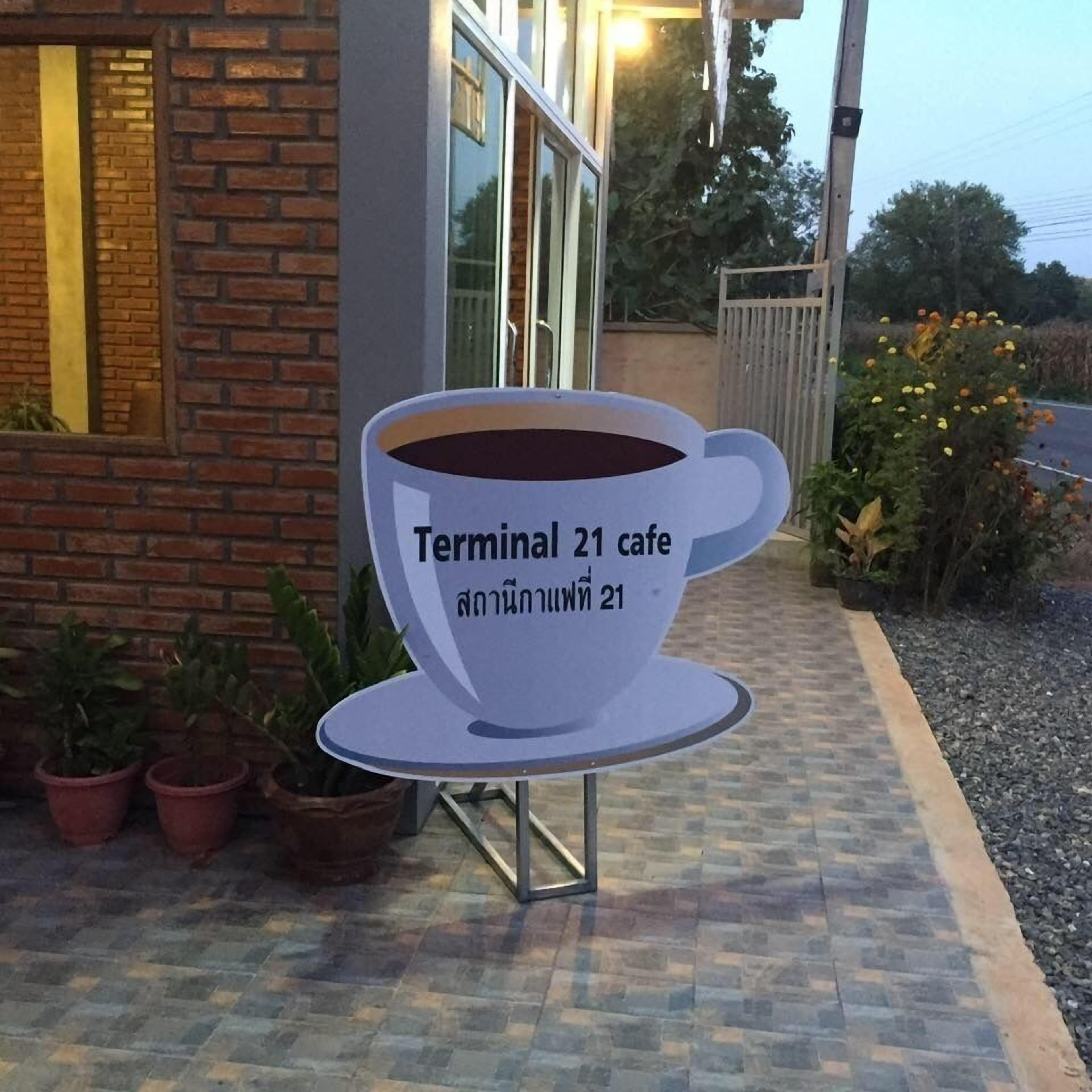 A sign for Terminal 21 cafe with a coffee cup design.