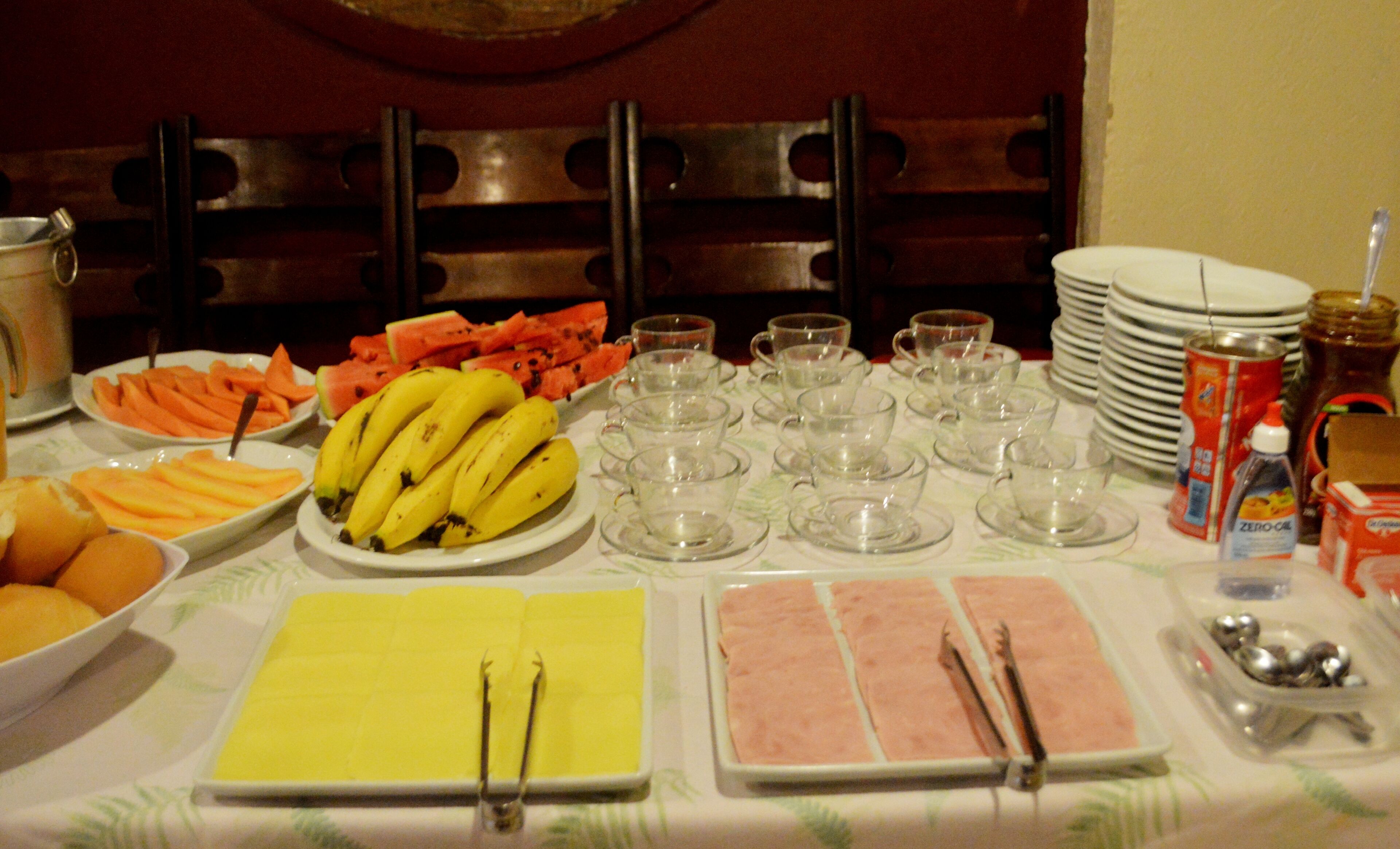 A buffet table with various food items and utensils.