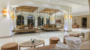 A spacious lobby with a high ceiling, large mirrors, and seating areas. - Occidental Sousse Marhaba (Sousse)