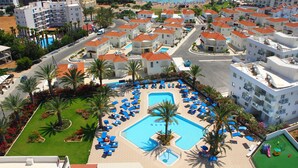 A resort with multiple buildings, a swimming pool, and a beach in the background. - Seagull Hotel Apartments (Paralimni)