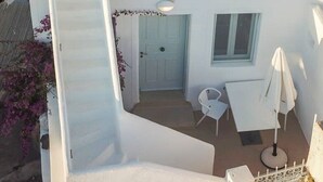 Un bâtiment blanc doté d’une piscine, d’un espace extérieur aménagé et d’un escalier.