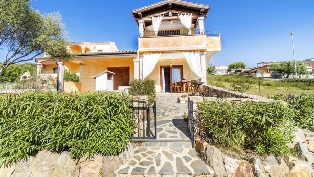A two-story house with a stone pathway leading to the entrance, surrounded by greenery. - Pedra De Oro | 2 Bedroom and Sea View! (Budoni)