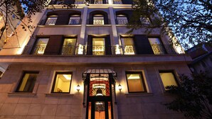 A multi-story building with a central entrance featuring a decorative archway and a series of balconies with wrought iron railings. - The Fox Hotel (Istanbul)