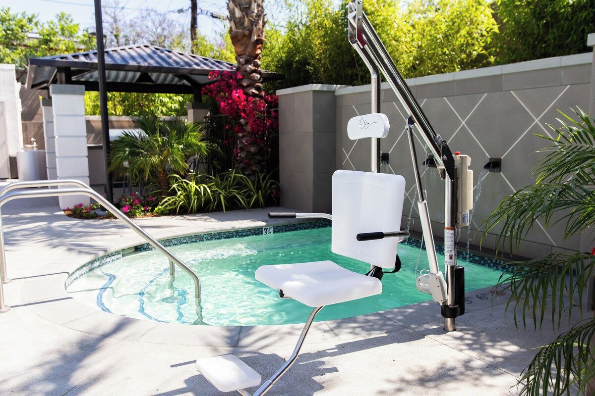 Spacious hot tub area with shaded seating and an accessibility lift