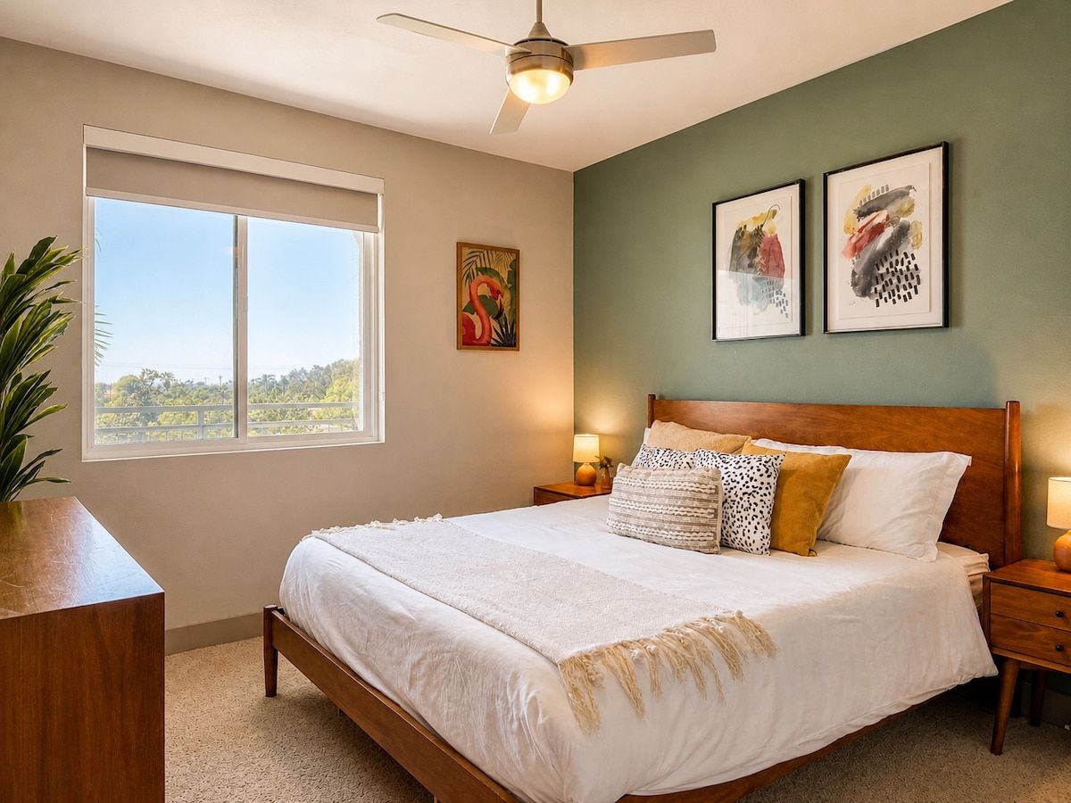 Bright bedroom with a comfortable bed, ceiling fan and sunny window