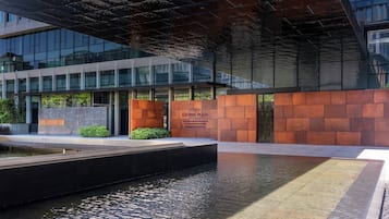 Welcome to Crown Plaza, where a beautiful water feature and pathway lead to the entrance.