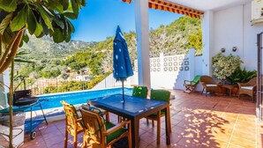 A patio with a pool, outdoor furniture, and a view of the surrounding landscape. - Monte Verde Ojén by Ruralidays (Málaga)