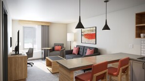 Una habitación de hotel moderna con zona de comedor, un conjunto de sofás, un escritorio con computadora y un ventanal con cortinas.