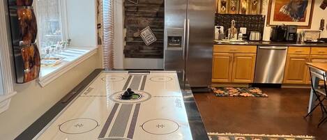A modern kitchen with a built-in stove, stainless steel appliances, and a decorative rug.