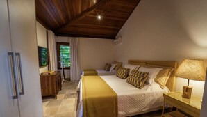 A bedroom with two beds, a wooden ceiling, a nightstand with a lamp, and a window with curtains. - Spectacular Luxury Mansion on the Beach. (Mata de São João)