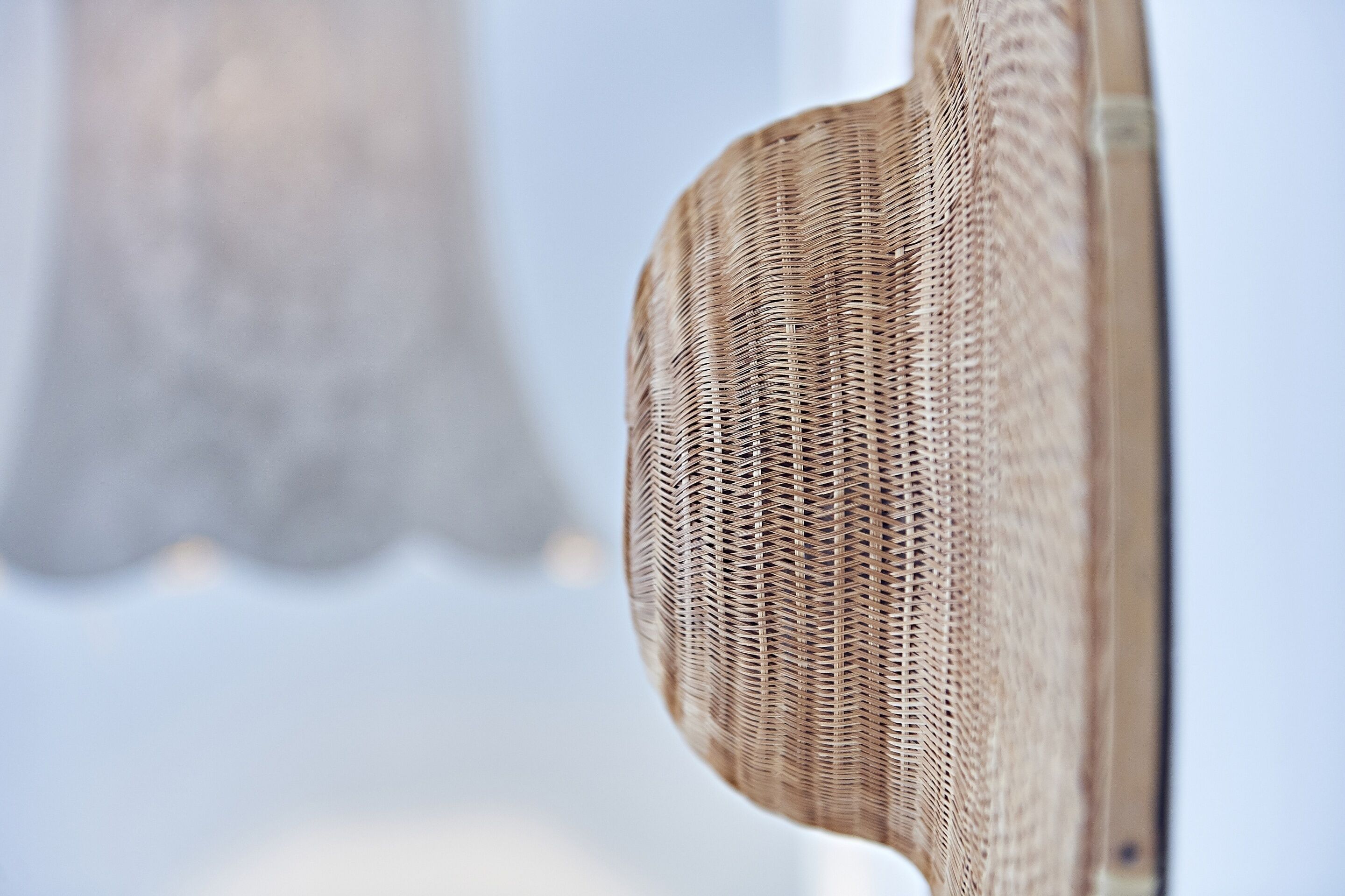 A close-up of a wicker chair with a woven texture.