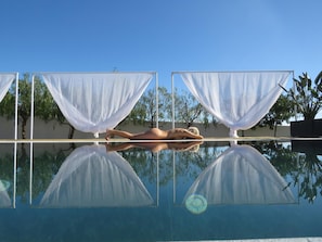 A pool with clear reflections, surrounded by white curtains and trees. - VILAPURA - Naturism (Tavira)