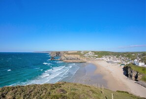 A coastal town with a sandy beach, rocky cliffs, and houses along the shore. - With uninterrupted sea views, this property enjoys a superb hillside position. (Lighthouse Hill)