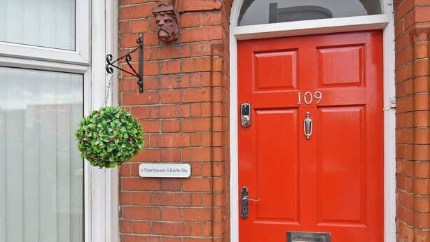 A red door with the number 109, a hanging green plant, and a sign reading "Townhouse @ Earle St." - Townhouse @ Earle Street Crewe (Crewe)