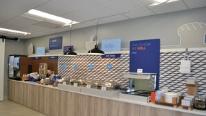 A buffet area with labeled sections for fruits, cereals, and hot foods. - Holiday Inn Express Tallahassee University Central by IHG (Tallahassee)