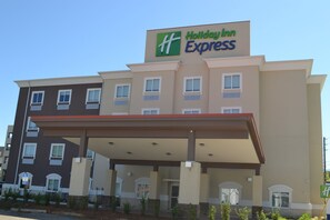 A Holiday Inn Express building with a covered entrance and multiple windows. - Holiday Inn Express Tallahassee University Central by IHG (Tallahassee)