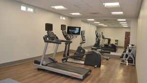 A gym with multiple treadmills, stationary bikes, and a mirrored wall. - Holiday Inn Express Tallahassee University Central by IHG (Tallahassee)
