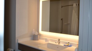 A bathroom with a white sink, a mirror, and a towel rack. - Holiday Inn Express Tallahassee University Central by IHG (Tallahassee)
