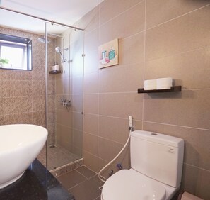 A bathroom with a glass-enclosed shower, a toilet, and a sink. - RUSTIC Home (Da Nang)