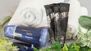 Un sèche-cheveux Panasonic, des serviettes blanches et un ensemble de brosses à dents.